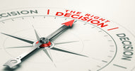 A white compass with a silver dial and red-tipped arrow points to the words "the right decision" written in red text.