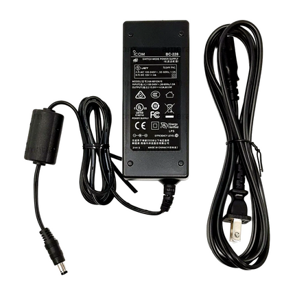 Close up of the manufacturer labeling and technical power specifications on the Icom BC228 power supply.